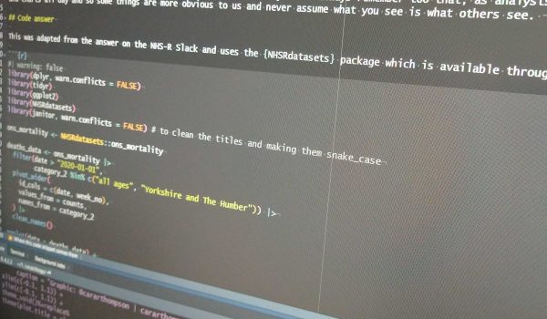 Photograph of a computer screen with R code