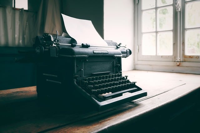 Photo of an old typewriter with the paper ready to be typed on